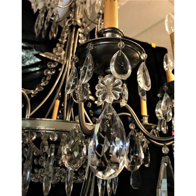 Very unique vintage chandelier! This large ten arm chandelier has a a nickel finish with many unique crystal adornments....