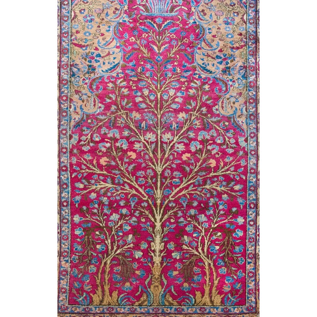 Woven in the 1930s in the historic city of Qum, this early 20th-century Persian prayer rug is a stunning example of the...