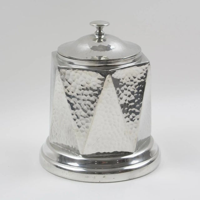 This elegant English Art Deco geometric hand-hammered dinanderie polished-pewter-covered decorative box or tea caddy was...