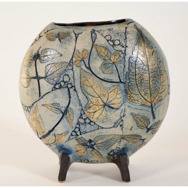 A beautiful hand made ceramic vase by Moon Gallery, Malaysia. Decorated with incised decorations of flowers and foliages....