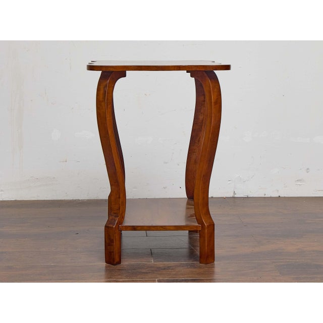 An Austrian Biedermeier side table from the 19th century, crafted in walnut with an elegant sense of balance and...