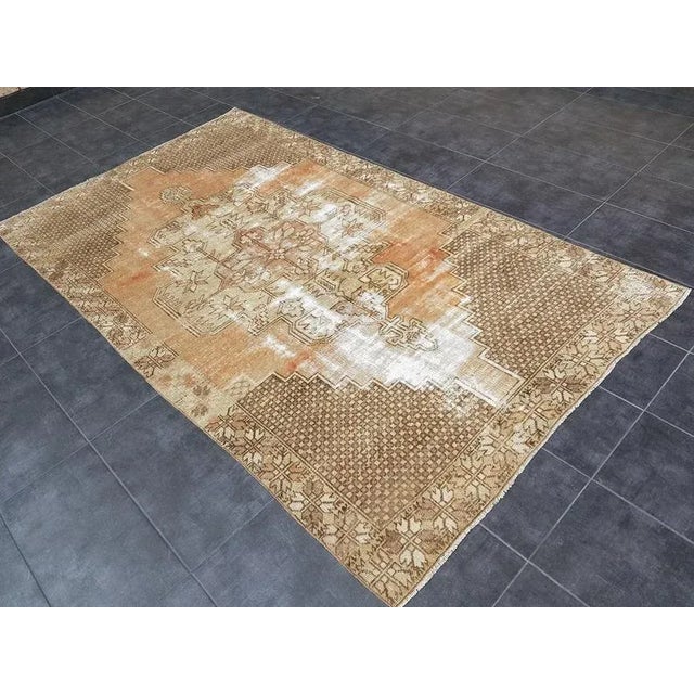 This is a vintage Turkish Oushak rug from the 1960s. The piece was hand-knotted.