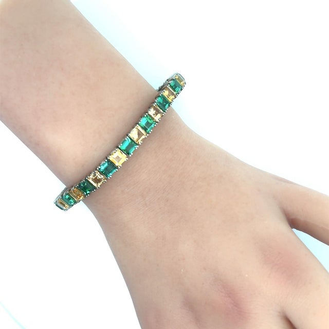 A chic line bracelet featuring interchanging square-shape tourmaline and topaz! The tourmaline have a soft and clean...