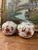 This matching pair of porcelain vases features a rounded, globular form decorated with stylized birds,butterflies, and...