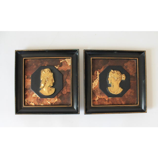 Pair of framed vintage silhouette art pieces featuring gold-toned profile portraits of ladies on a textured background....