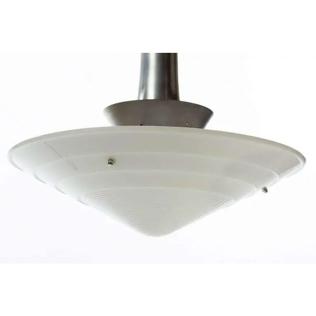 Original 1950s Gerald Thurston for Lightolier chandelier. Features a milk glass dome shade that suspends from a circular...