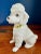 Very cute figurine of a white poodle with a yellow collar. Stamped Japan on the bottom.