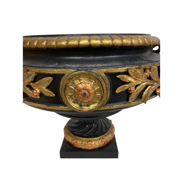 Pair of Victorian black and gold classical cast iron urns. Spectacular pair with bow, garland and medallion decoration....
