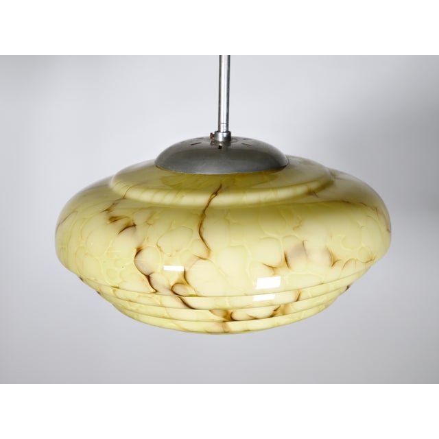 Art Deco ceiling lamp made of marbled opal glass, 1920s–1930s. Tiered lampshade with a softly rounded shape and brown...