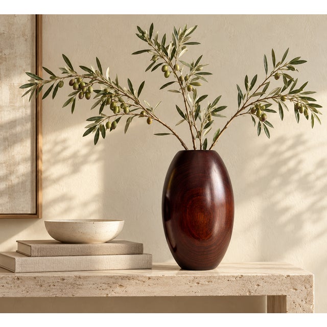 A sculptural walnut vase with a softly rounded, elongated silhouette and beautifully expressive grain. Deep chocolate and...