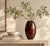 A sculptural walnut vase with a softly rounded, elongated silhouette and beautifully expressive grain. Deep chocolate and...