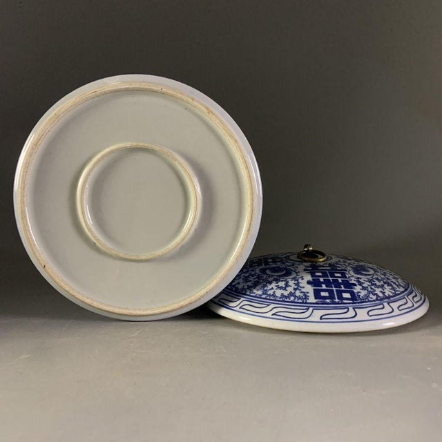 This unique jar features a wide, cylindrical body with a large opening, topped with a matching domed lid finished with a...