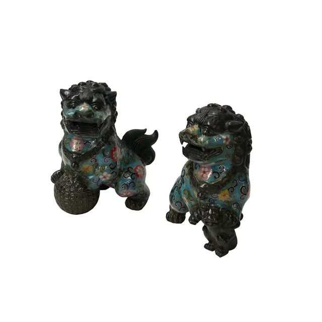 This pair of ornate Chinese Guardian Lions, or Shishi, showcases the intricate artistry of cloisonné enamel on a dark,...
