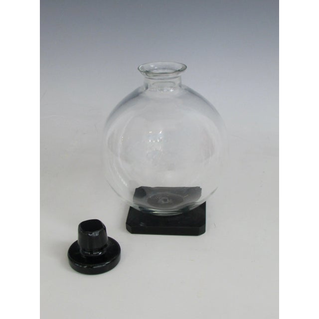 Fine Art Deco era decanter . Clear glass ball on black onyx glass base accented with matching black top . Superb Art Deco...