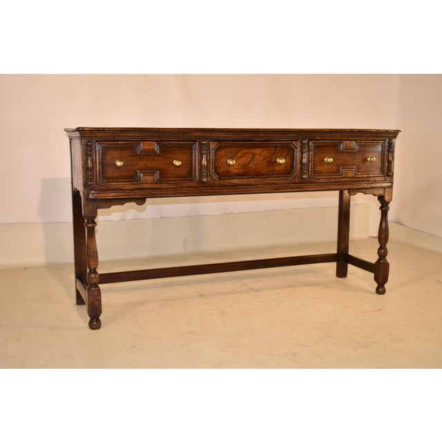 Circa 1900 geometric elm sideboard from England. This sideboard is stylistically from the Jacobean period, but was made in...