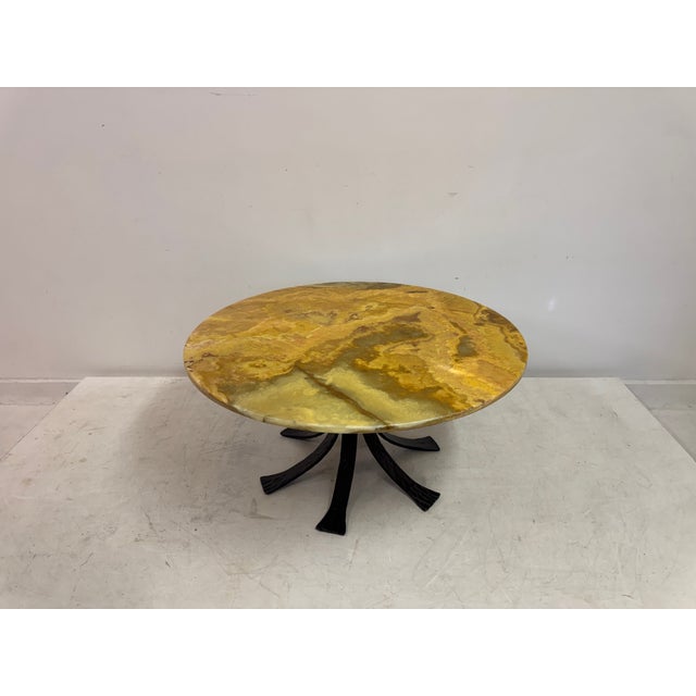 Round coffee table Onyx top on a wrought iron base Late 20th Century Europe.