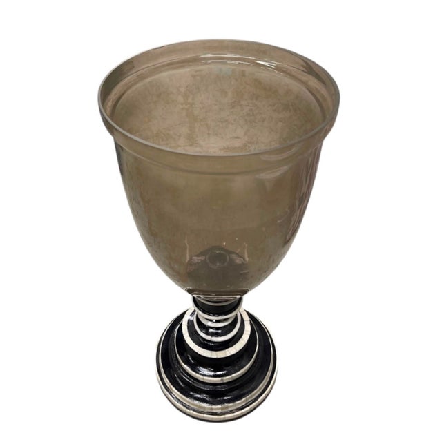 Elevate your home décor with this striking vintage hurricane candle holder, blending grand classical form with bold,...