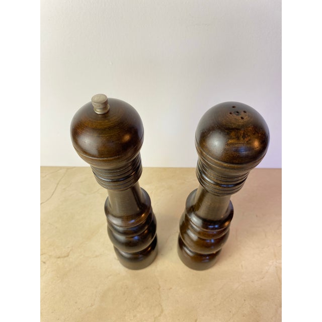 A handsome vintage salt and pepper mill set crafted from richly toned hardwood and made in Japan. Featuring classic turned...
