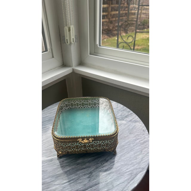 Beautiful, ornate antique jewelry box with velvet interior. Wear, including to velvet cushion, is consistent with the age...