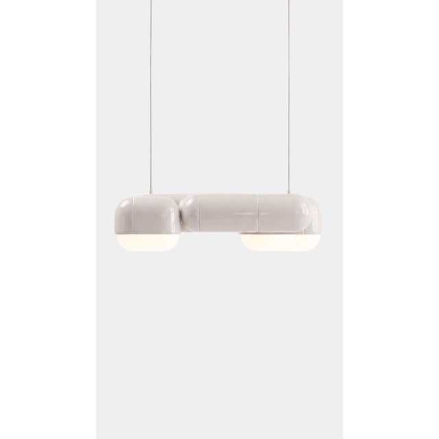 A pendant that changes with the day. In daylight its printed shell reads crisp and architectural, all shadow and ridge;...