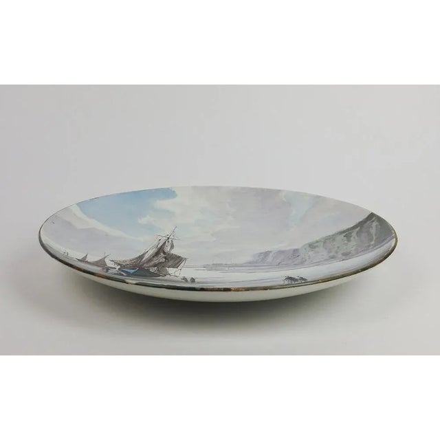 Fine earthenware dish with polychrome painted decoration representing a maritime landscape of the Côte d'Albâtre: cliffs,...