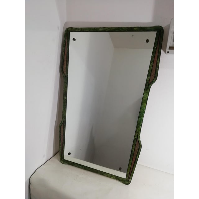 Beautiful shield-shaped mirror with enamel decoration, then fired, on the back. The colors are beautiful and made from...