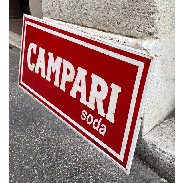 Beautiful original CAMPARI Soda advertising sign, made of enameled metal, with an iconic red background and embossed white...
