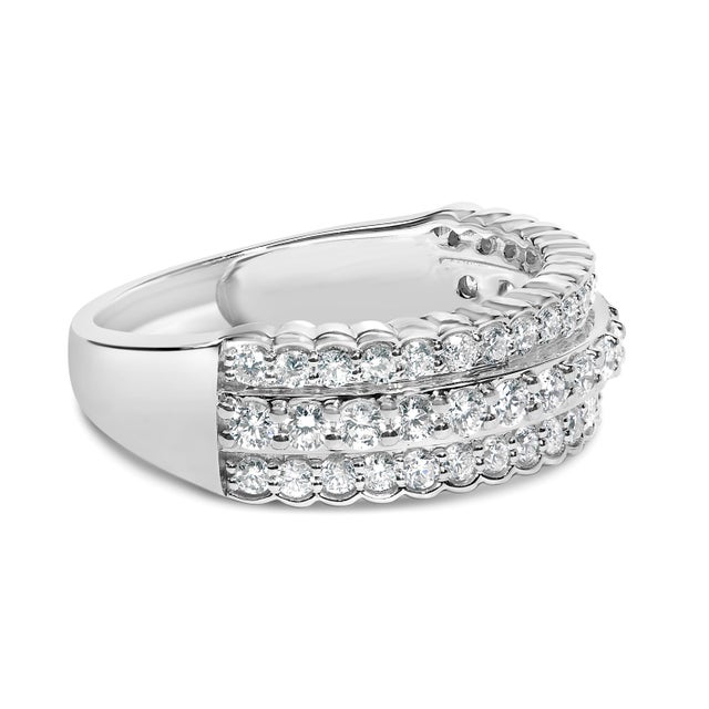 Immerse yourself in the ethereal brilliance of this sterling silver band, gracefully embellished with three rows of lab-...