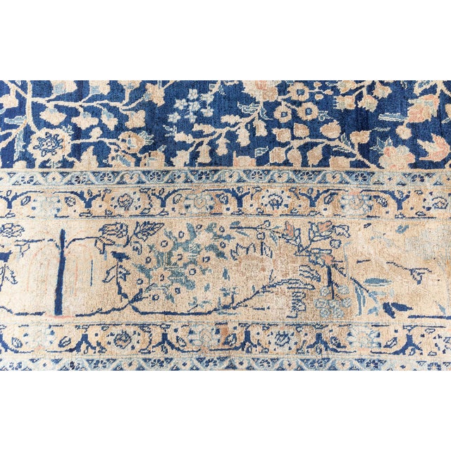 This antique Persian Tabriz carpet (circa 1900) exemplifies the masterful artistry of early 20th-century Northwest Iran....