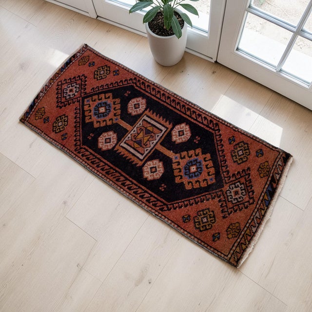 This exquisite vintage Oushak rug features a striking geometric composition, blending deep charcoal and earthy terracotta...