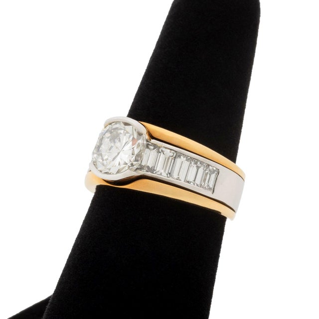 Vintage Platinum, 18K Yellow Gold, and Diamond Ring, featuring one partial bezel set round brilliant cut diamond, weighing...