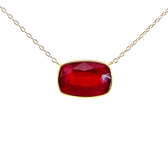 A striking fine jewelry piece displaying rich, fiery color, this elegant station necklace is forged in solid 18K yellow...