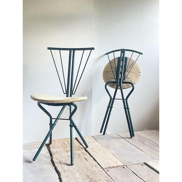 A distinctive and elegant pair of La Palma folding chairs, manufactured in Italy during the 1970s. The chairs feature...