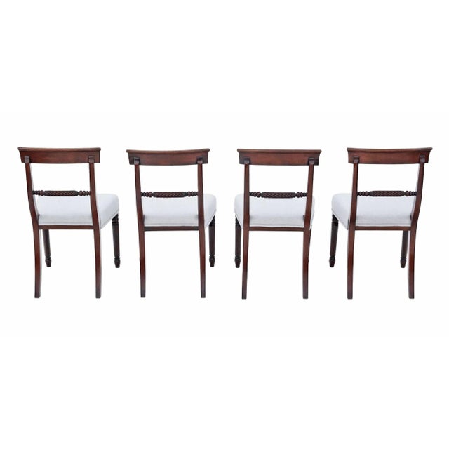 A rare decorative find, this set of four early 19th-century mahogany dining chairs is full of age, character, and patina....