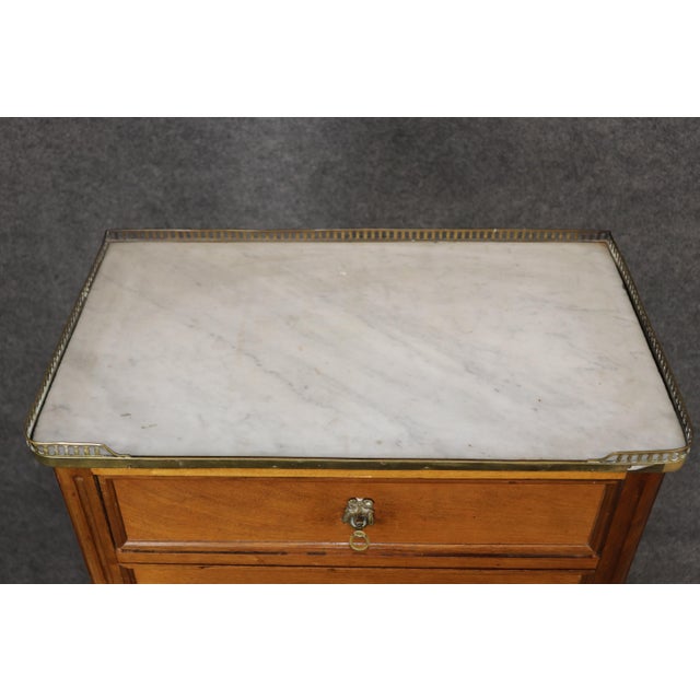 An elegant and architecturally refined French Louis XVI style bronze-mounted mahogany high chest, dating to the 1940s,...
