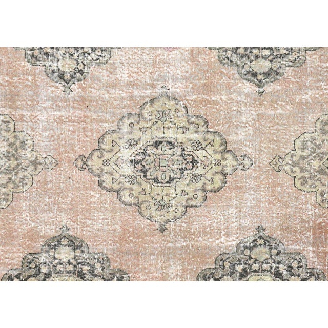 A vintage Turkish Oushak measuring 4'7" x 13'2", hand-woven with wool on wool foundation. This piece displays the region's...