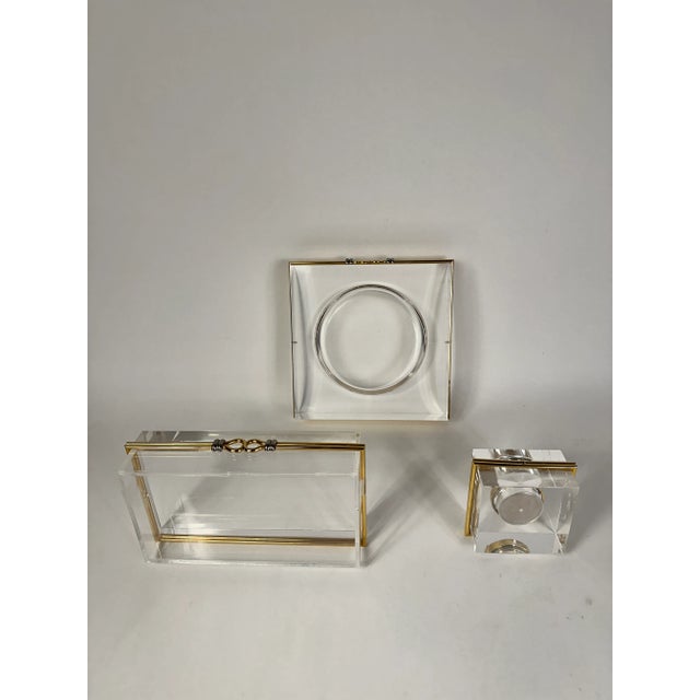 3 piece set of vintage lucite with gold and chrome banded pieces from Palm Beach 1970's. An ashtray, lighter and box in...
