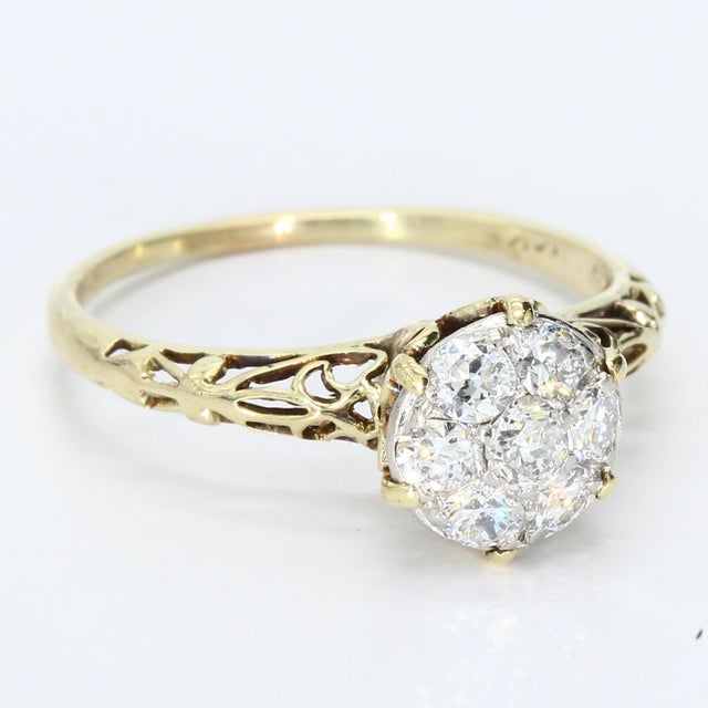This exquisite cluster ring showcases a captivating arrangement of diamonds set in 14k yellow gold. The centerpiece...