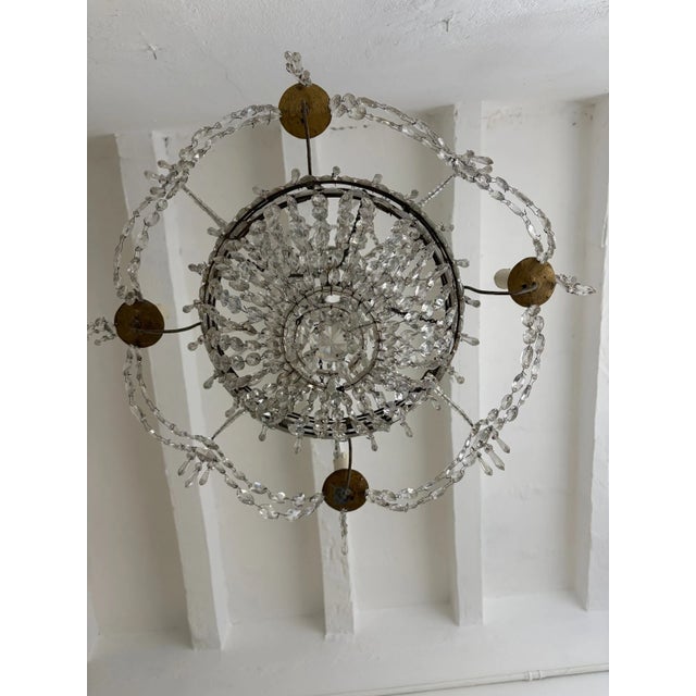 Housing 4 lights, sitting on metal posts that slide into a small pocket on chandelier. This chandelier was made for...