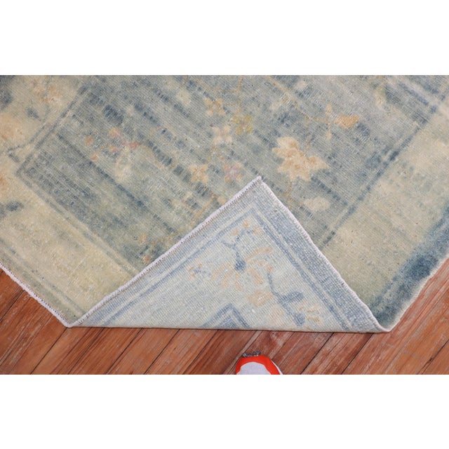 An early-20th-century scatter size Chinese rug in a faded watery blue color, accents in ivory and pink Measures: 3'2 x 4'9''.