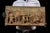 Decorative cast-plaster relief plaque rendered in the Neoclassical style with a warm, bronze-toned finish. The lively...