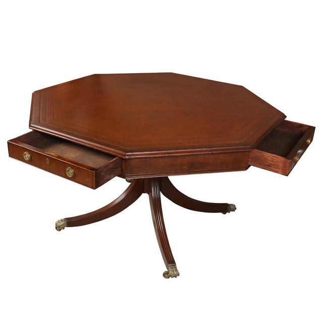 A Regency style center table crafted in rich mahogany, featuring a distinctive octagonal top inset with a finely tooled...