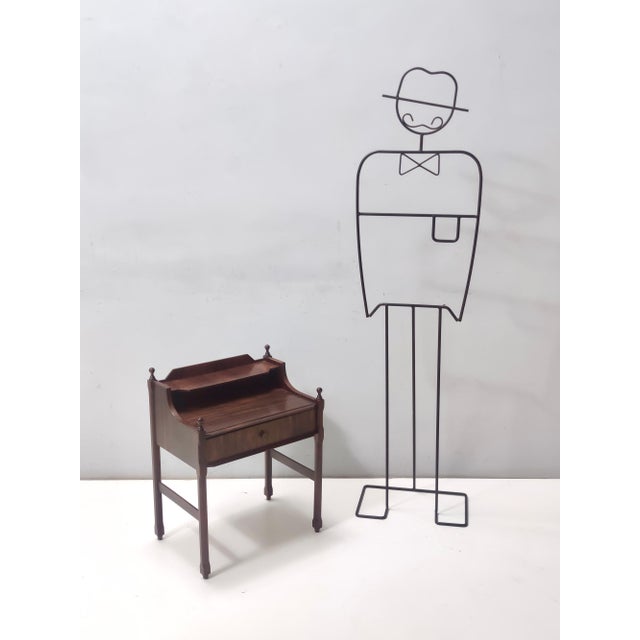 Made in Italy, 1970s. This nightstand features a walnut frame. It might show slight traces of use since it's vintage, but...