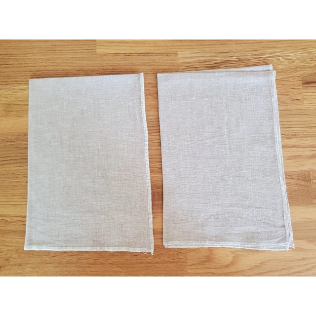 This pair of tea towels, kitchen towels, or dish towels are made of an apparel weight yarn dyed linen in light tan or...