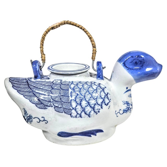 Go to the pictures, my words aren't good enough. Bamboo wrapped metal handle on a gorgeous blue flow duck shaped teapot....