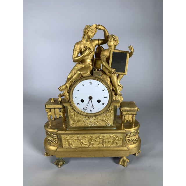 Empire or Directoire period clock Depicts Venus adjusting her diadem before a mirror held by Cupid. Exceptional chasing...
