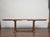 A solid 19th-century French fruitwood dining table with a classic provincial character and a practical extension system....