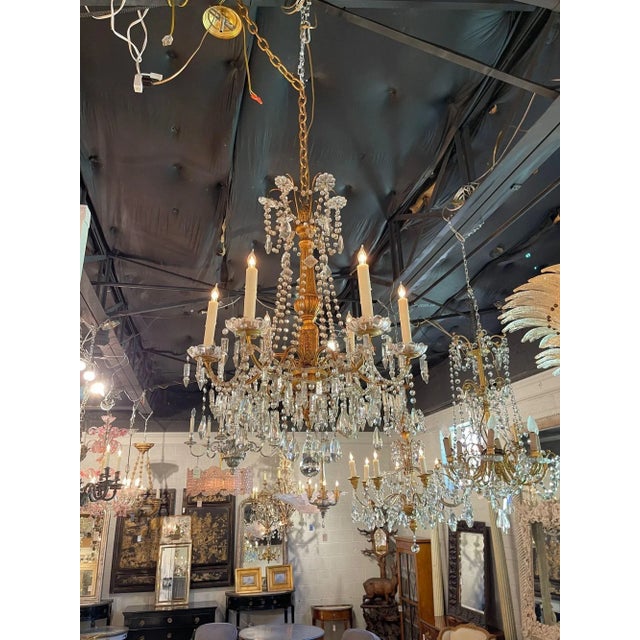Exquisite 19th century Italian giltwood and beaded chandelier with 6 lights. Featuring a carved giltwood base and gorgeous...