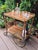 An elegant mobile bar cart from the 1970s, designed in the distinctive Hollywood Regency style. The design combines brass...
