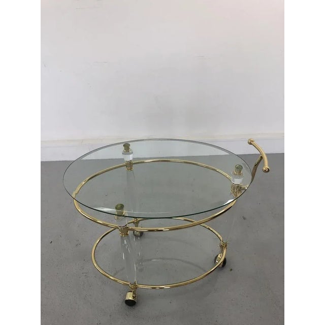 Bar serving cart trolley in acrylic structure and brass details with two glass shelves. Original from Italy, 1960s.
